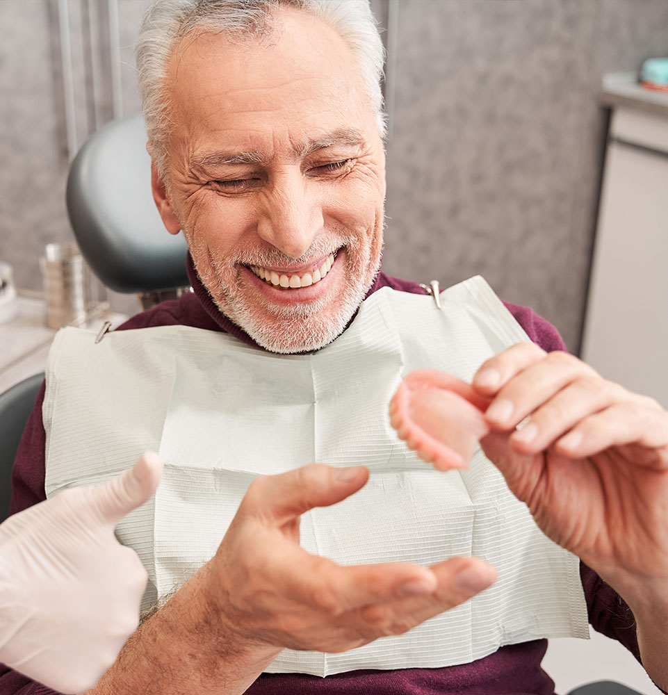 dental patient holding dentures
