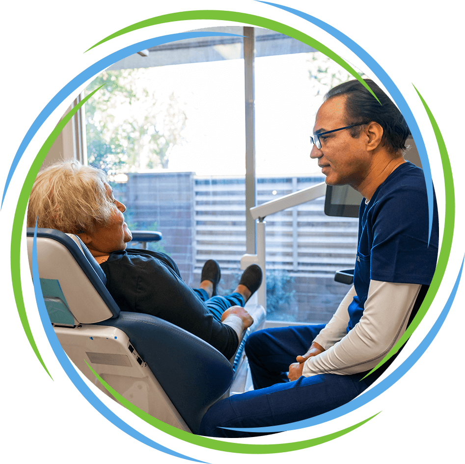 Dr. Muhammad Randhawa talking to patient about smile makeover dental procedures