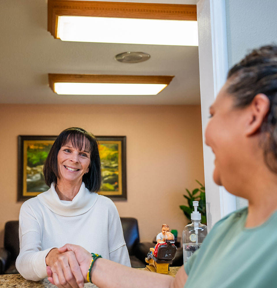 team member welcoming patient into hughson Family Dentistry